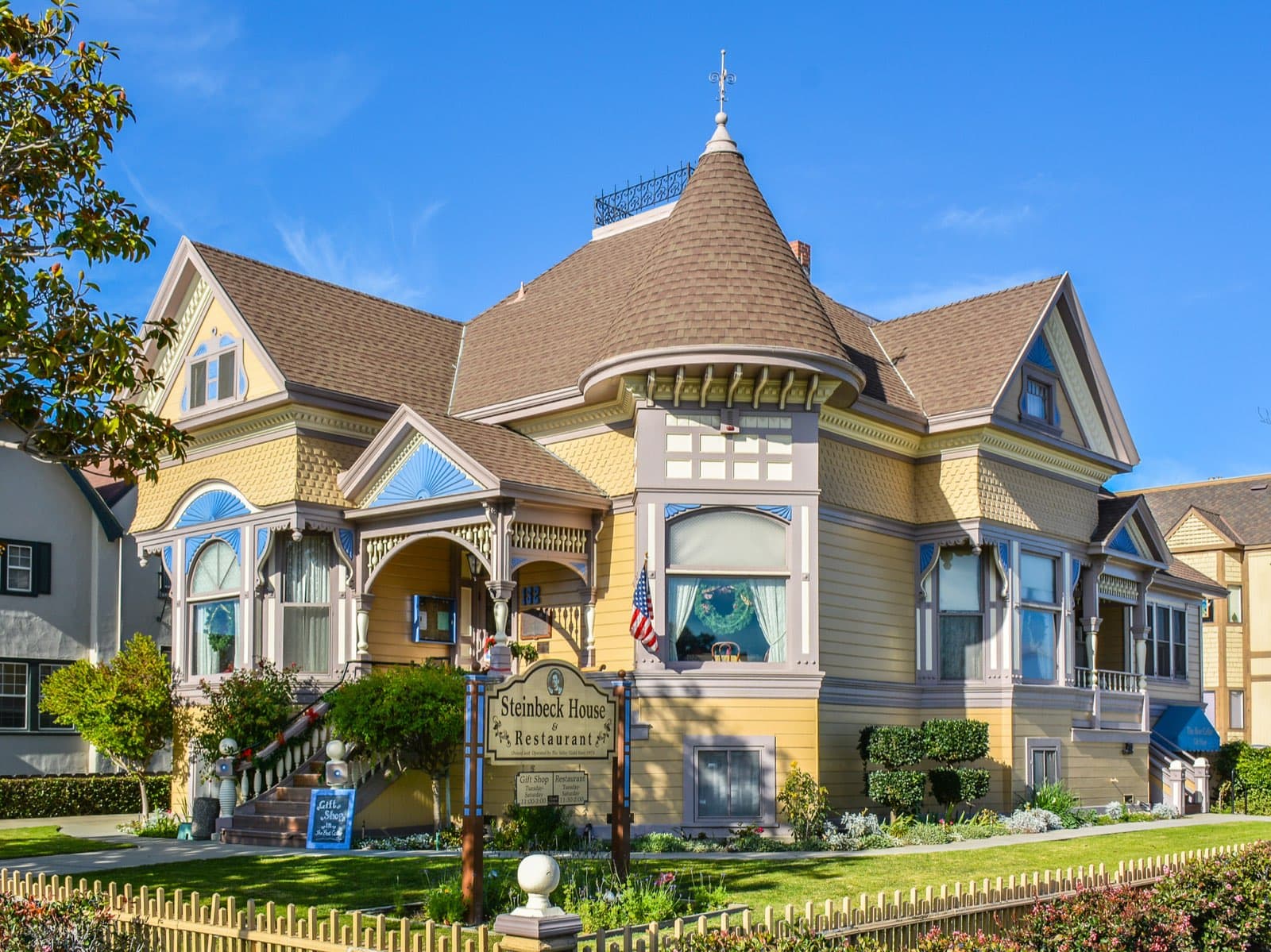 The Steinbeck House at 132 Central Avenue in Salinas, a yellow Queen Anne Victorian with a conical shingled turret, run as a restaurant and gift shop by the Valley Guild