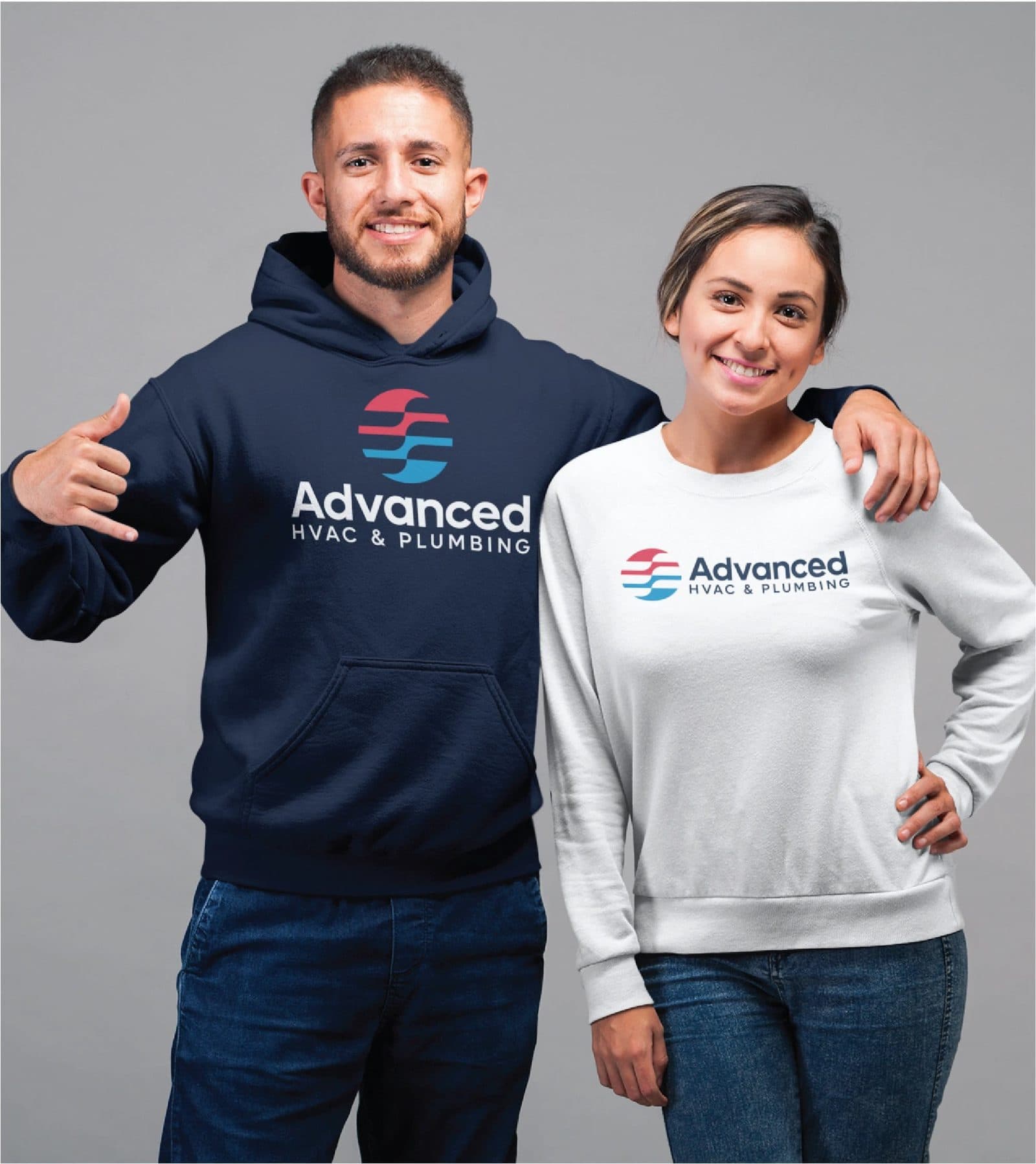 Two team members in a branded navy hoodie and a white branded sweatshirt